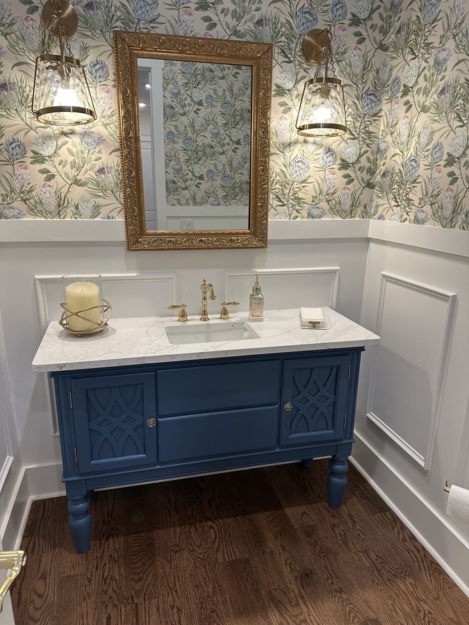 Powder room vanity with fretwork doors and turned legs